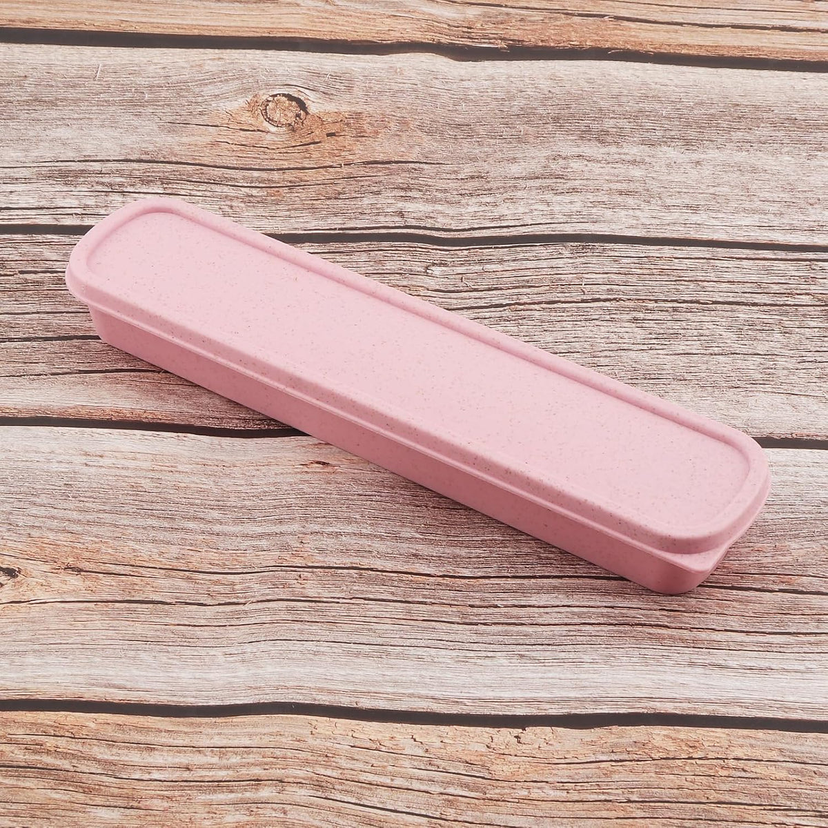 Pink cutlery storage case viewed from the side